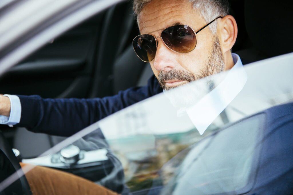 Man with sunglasses driving car 2022 12 16 22 33 07 utc 2048x1365
