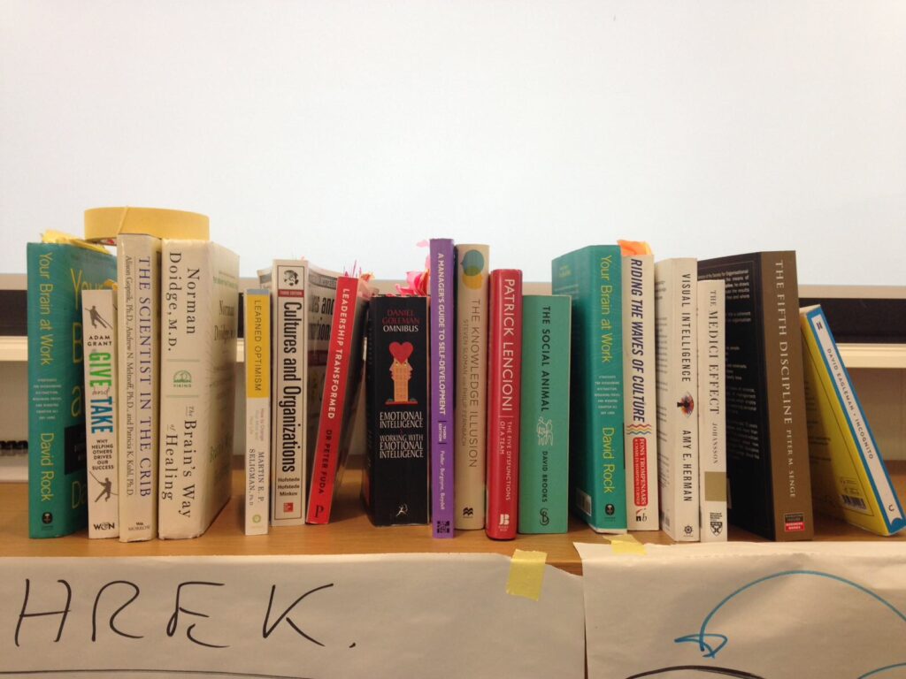 Old books on a wooden bookshelf illustrating the neuroscience, psychology, and cognitive reasons why people leave books half read.