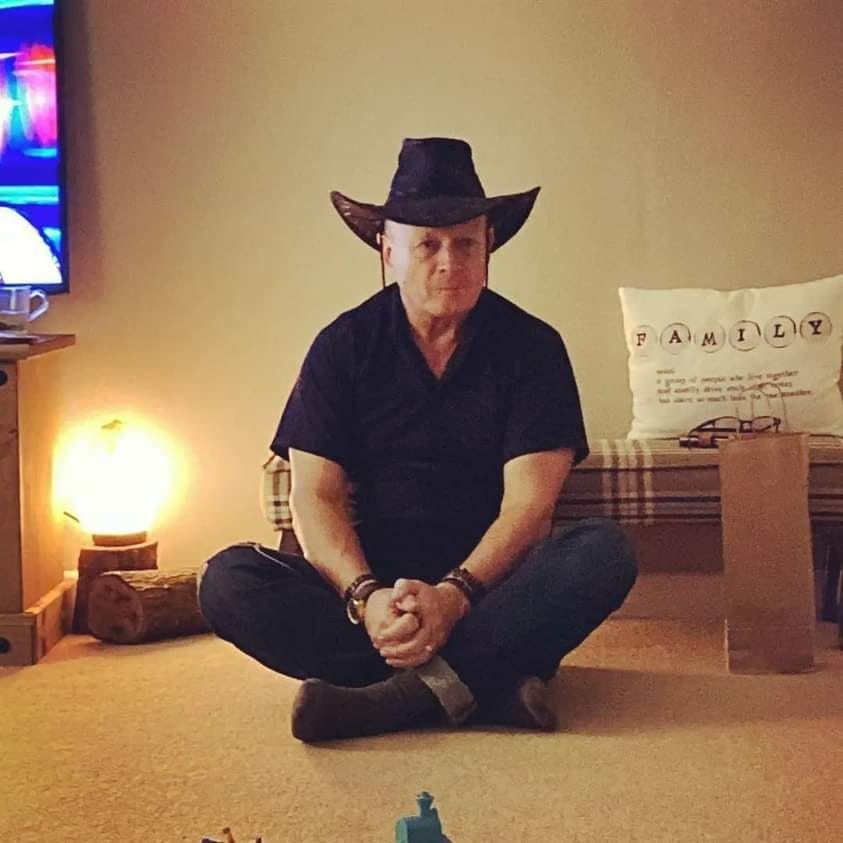 Man in a cowboy hat, pouting expression